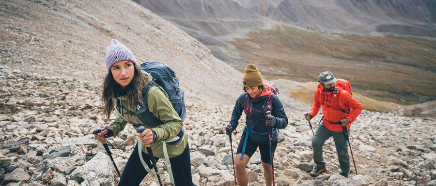 Three hikers in the fog use Pursuit Poles. 