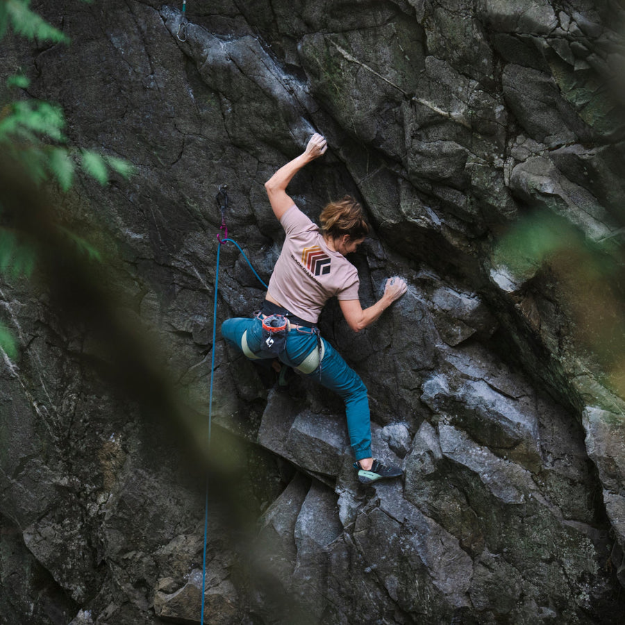 A climber on a granite wall wears a BD tee. 